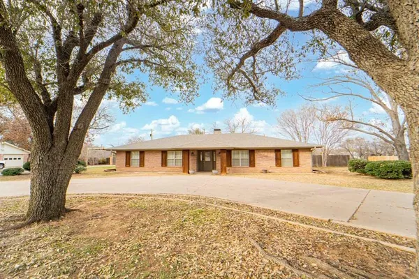 front view of house with a trees