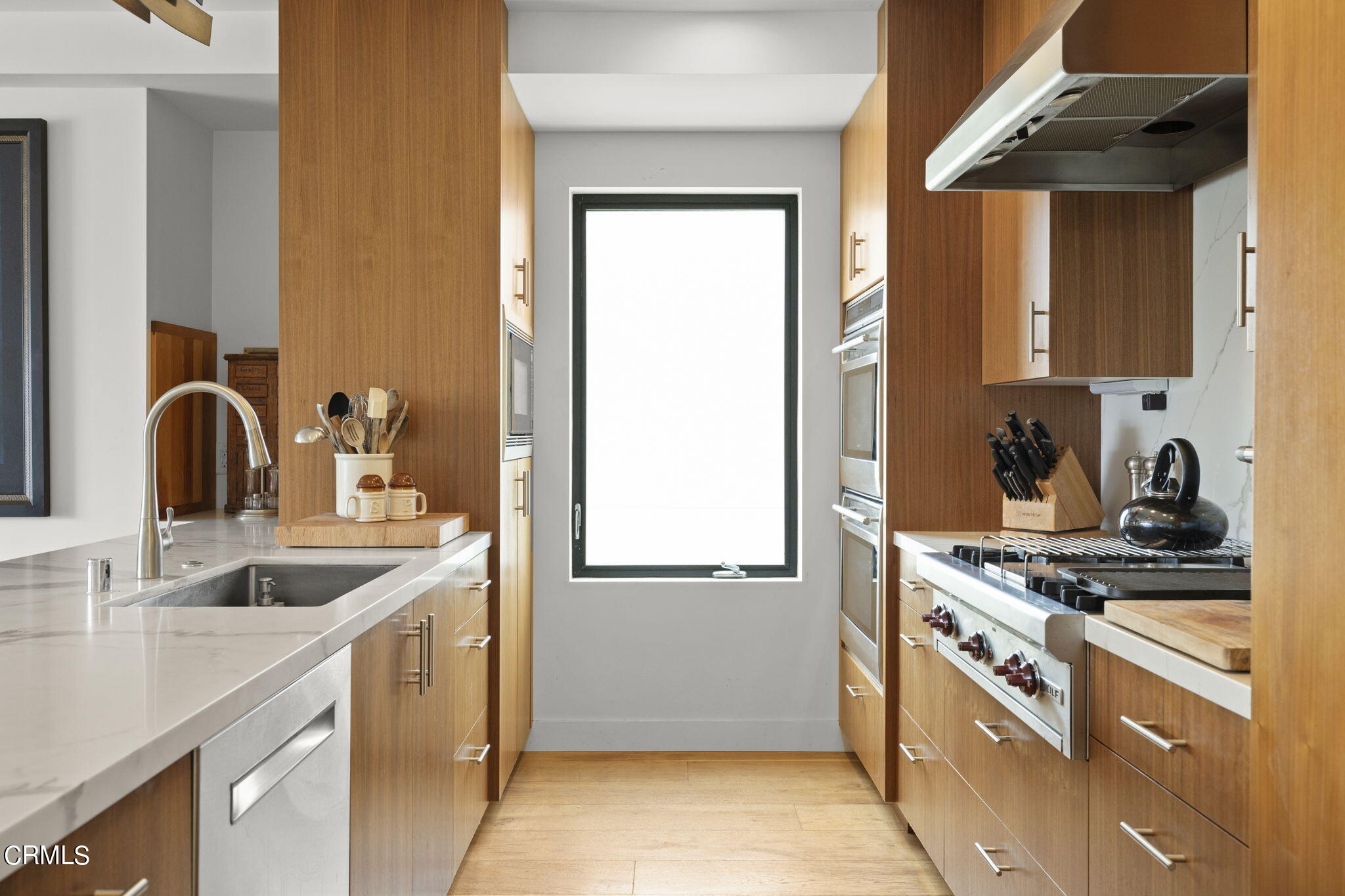 124 Ocean Drive Oxnard, CA 93035 - Photo 15 of 53 a kitchen with a sink stove top oven and cabinets