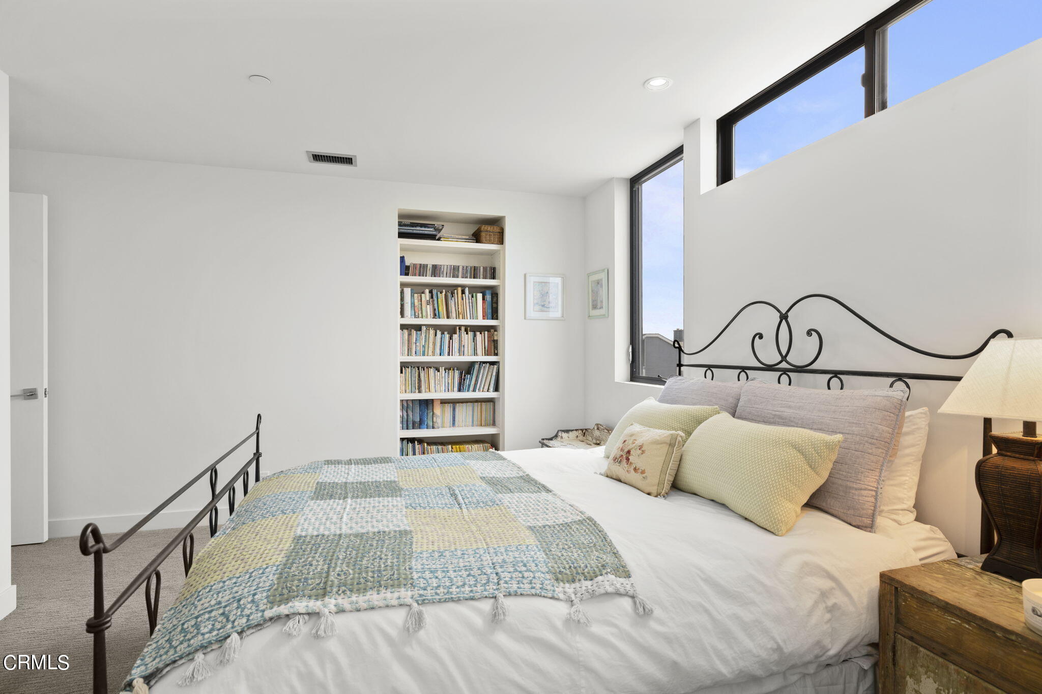 124 Ocean Drive Oxnard, CA 93035 - Photo 33 of 53 a bedroom with a bed and a book shelf