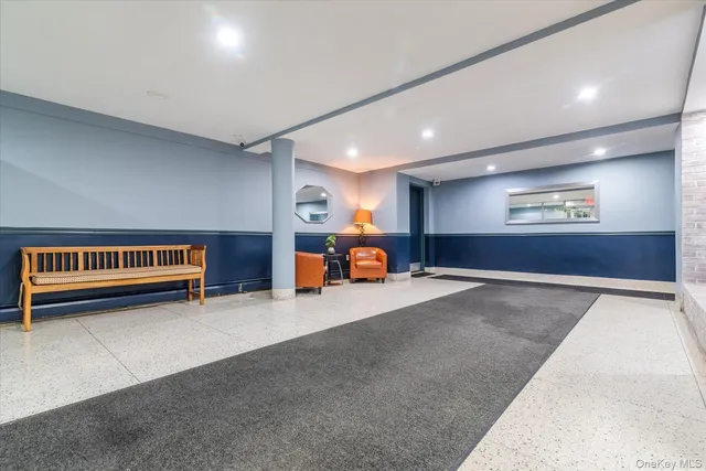 a living room with furniture and a lamp