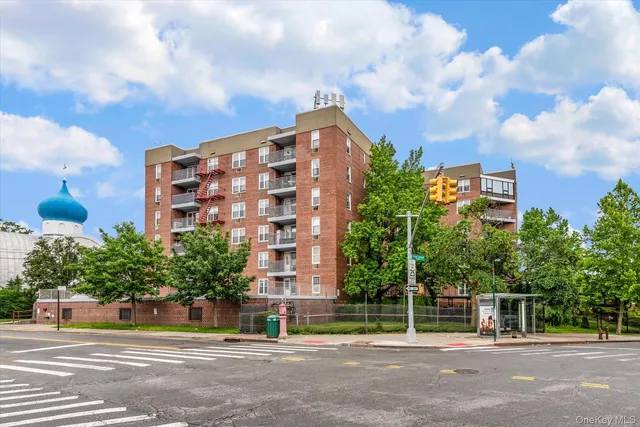 a view of a tall building next to a road