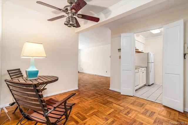a bedroom with a bed and a lamp on the dresser