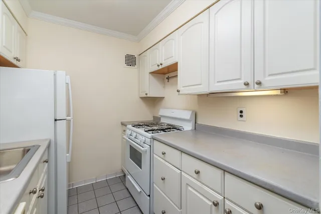 a kitchen with stainless steel appliances white cabinets and a stove