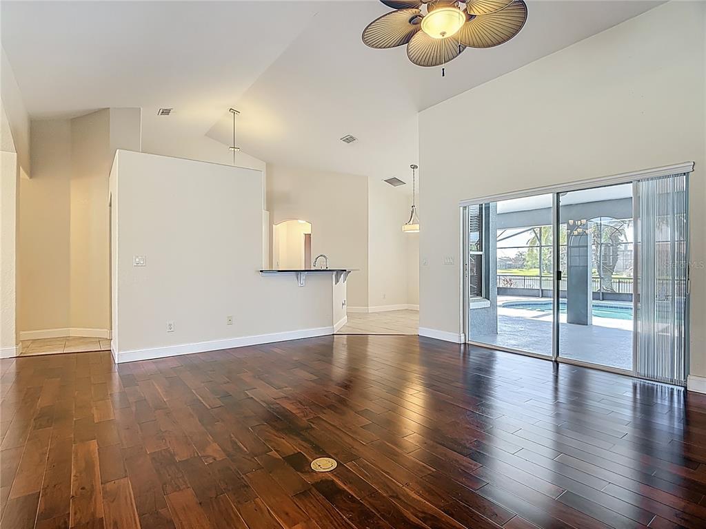 3189 Bayview Lane St. Cloud, FL 34772 - Photo 11 of 41 a view of an empty room with wooden floor and a window