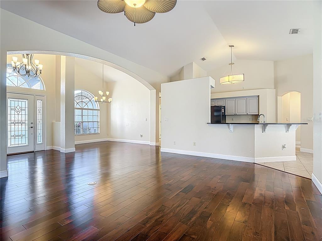3189 Bayview Lane St. Cloud, FL 34772 - Photo 12 of 41 an empty room with wooden floor and windows