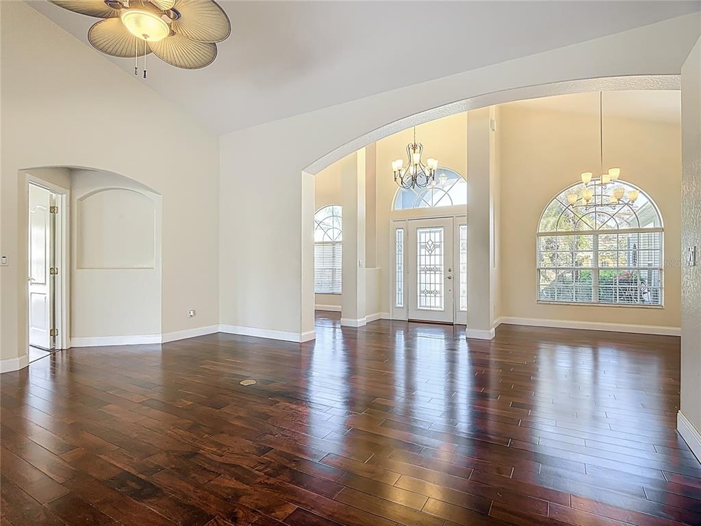3189 Bayview Lane St. Cloud, FL 34772 - Photo 13 of 41 an empty room with wooden floor and windows
