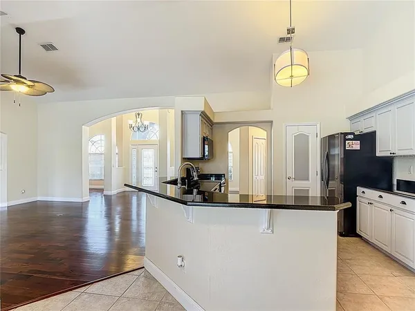 a view of a living room and chandelier with wooden floor