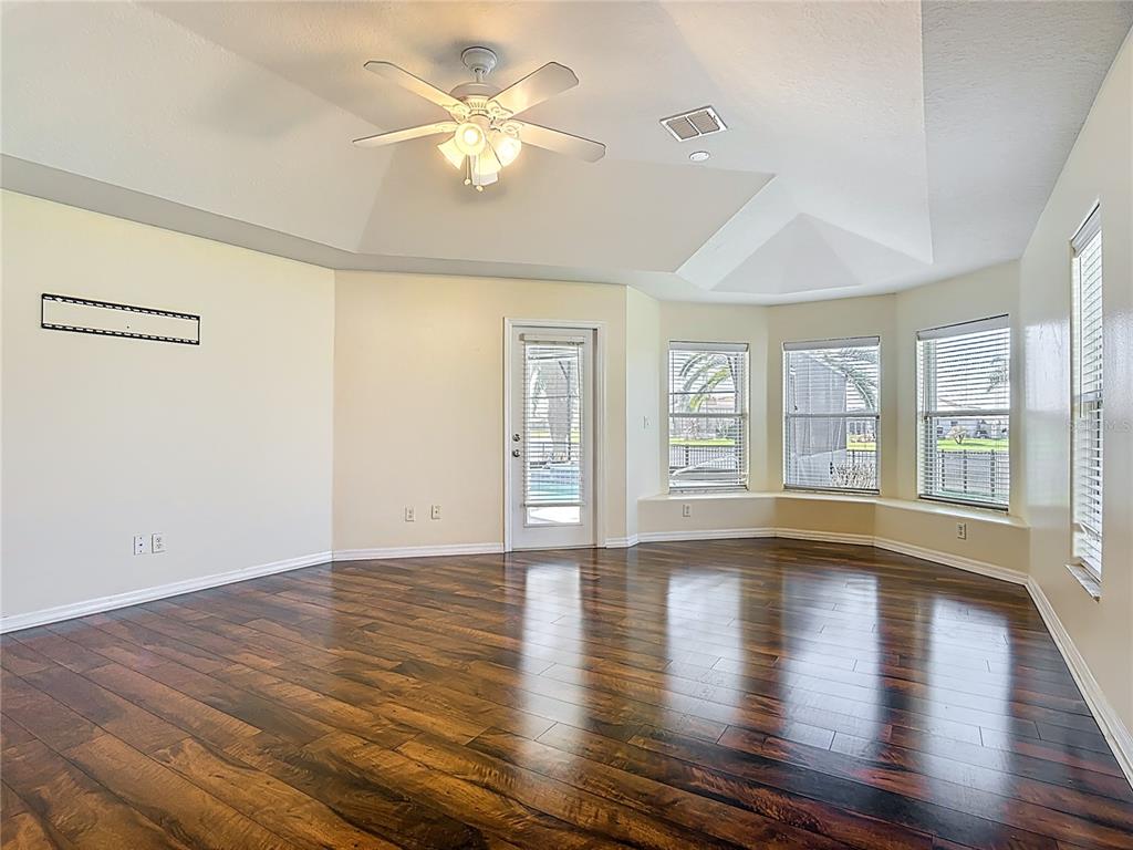 3189 Bayview Lane St. Cloud, FL 34772 - Photo 20 of 41 a view of an empty room with wooden floor and a window