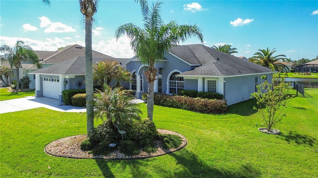 3189 Bayview Lane St. Cloud, FL 34772 - Photo 2 of 41 a front view of a house with garden