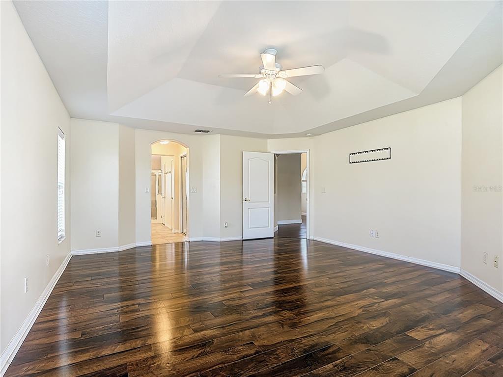 3189 Bayview Lane St. Cloud, FL 34772 - Photo 21 of 41 a view of an empty room with wooden floor and a window