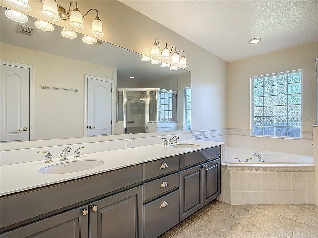 3189 Bayview Lane St. Cloud, FL 34772 - Photo 22 of 41 a bathroom with a sink double vanity and a bathtub