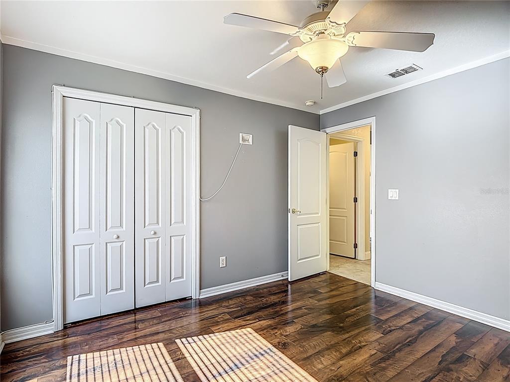 3189 Bayview Lane St. Cloud, FL 34772 - Photo 24 of 41 a view of an empty room with wooden floor