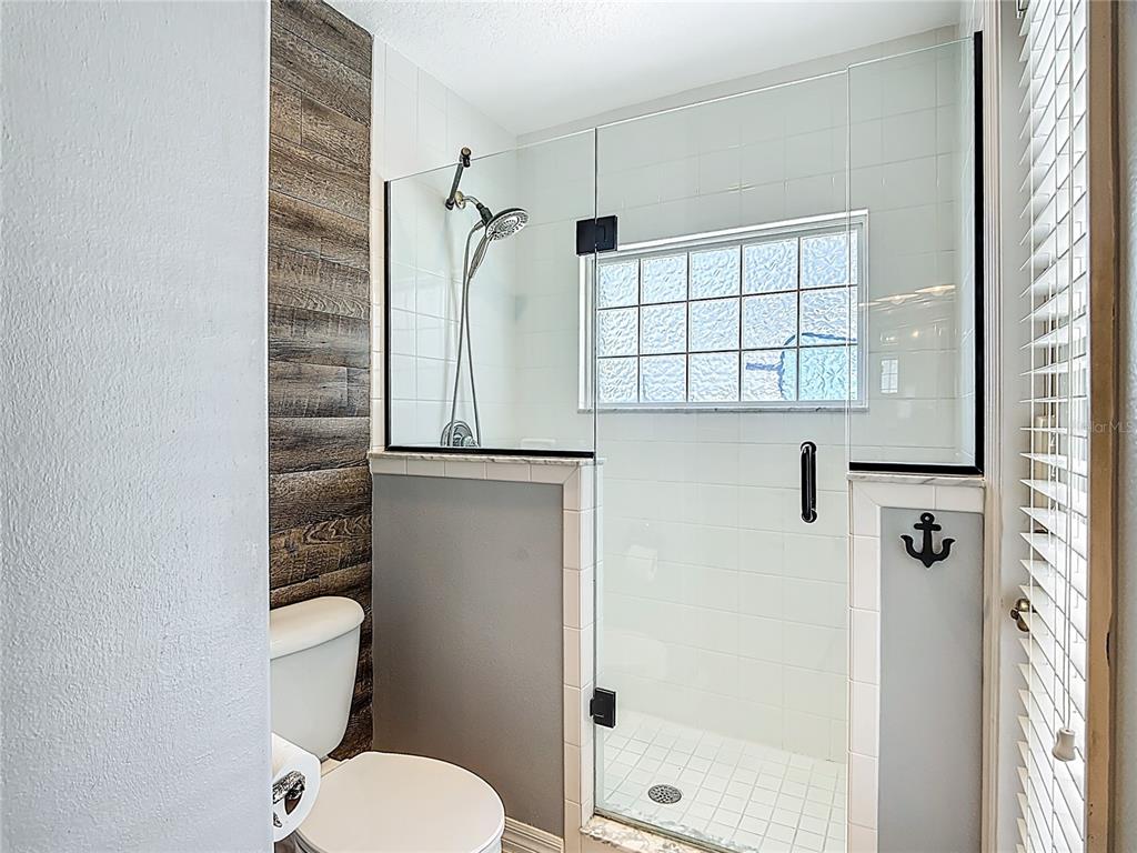 3189 Bayview Lane St. Cloud, FL 34772 - Photo 26 of 41 a white toilet sitting next to a bathroom sink