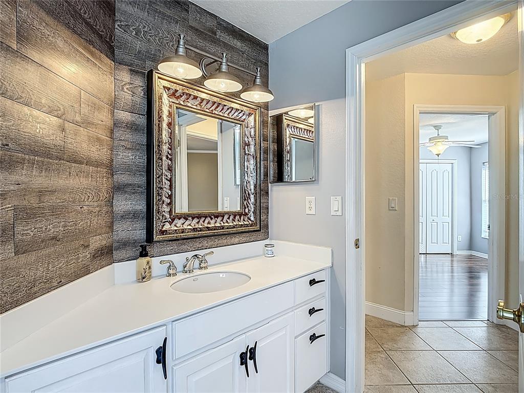 3189 Bayview Lane St. Cloud, FL 34772 - Photo 27 of 41 a bathroom with a sink and a mirror