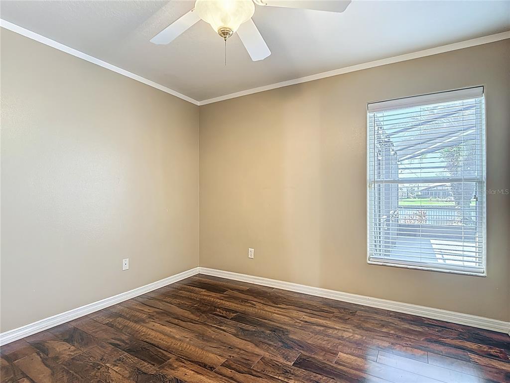 3189 Bayview Lane St. Cloud, FL 34772 - Photo 28 of 41 a view of an empty room with wooden floor and a window
