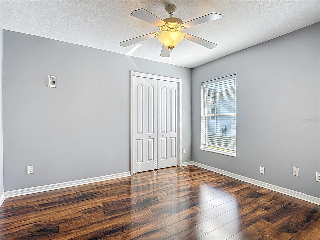 3189 Bayview Lane St. Cloud, FL 34772 - Photo 29 of 41 an empty room with wooden floor and a window
