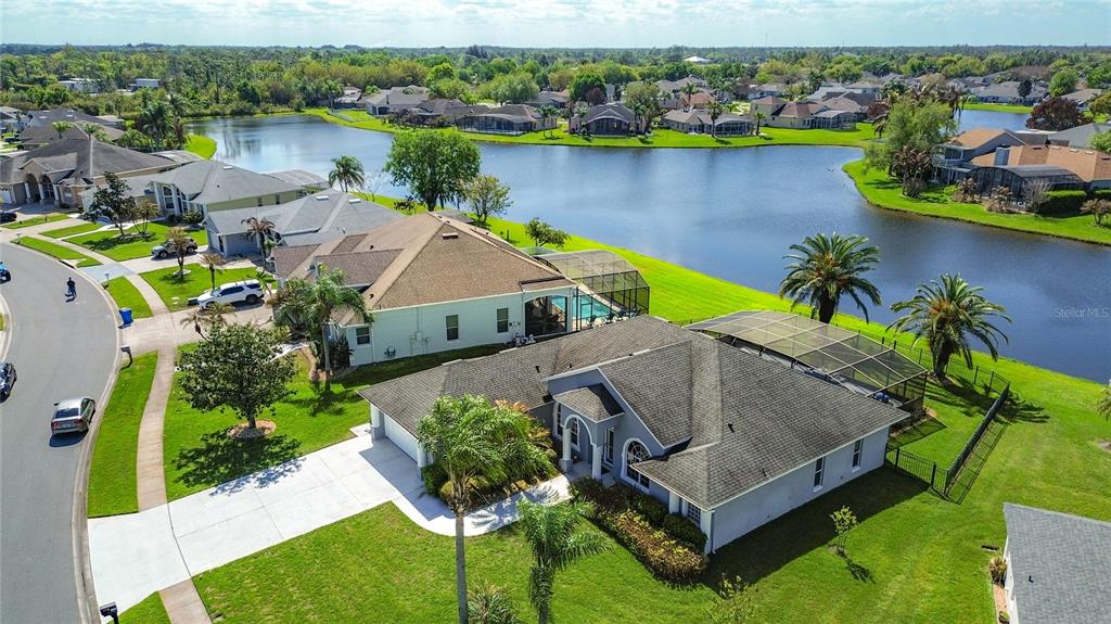 3189 Bayview Lane St. Cloud, FL 34772 - Photo 3 of 41 an aerial view of a house with a garden and lake view