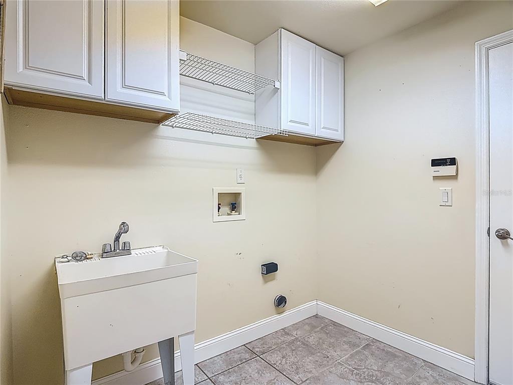 3189 Bayview Lane St. Cloud, FL 34772 - Photo 31 of 41 a bathroom with a sink and cabinets