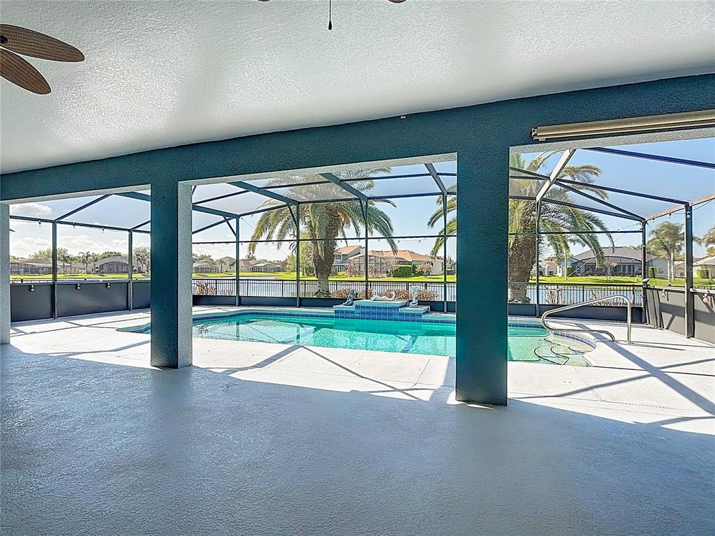 3189 Bayview Lane St. Cloud, FL 34772 - Photo 33 of 41 an empty room with sliding glass door and wooden floor