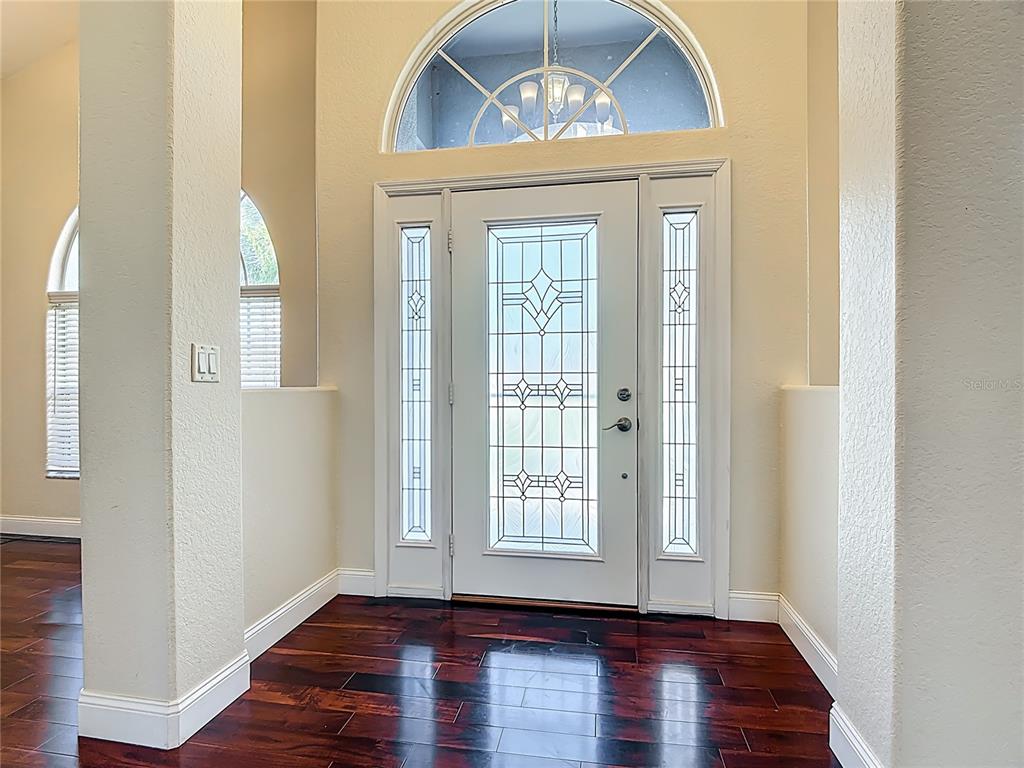 3189 Bayview Lane St. Cloud, FL 34772 - Photo 6 of 41 a view of a livingroom with wooden floor and a window