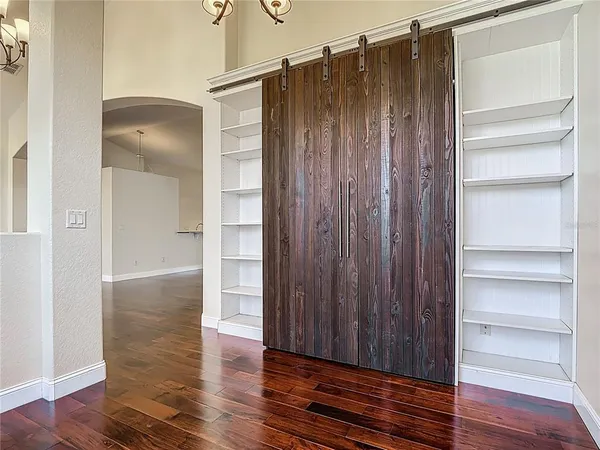 a view of walk in closet with wooden floor