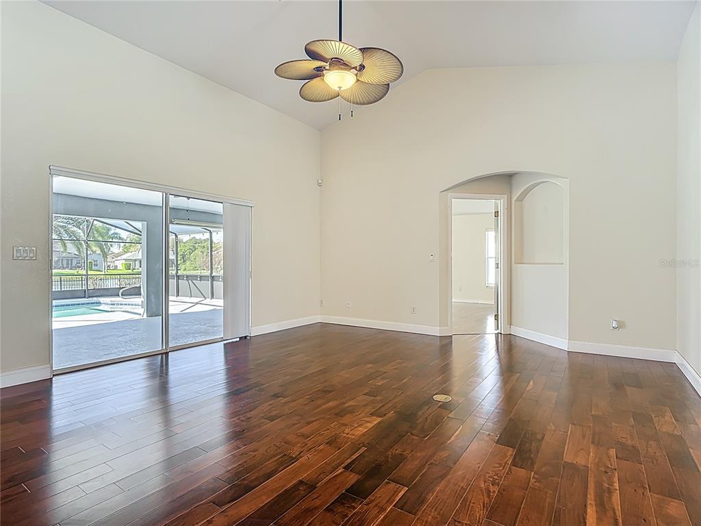 3189 Bayview Lane St. Cloud, FL 34772 - Photo 10 of 41 a view of an empty room with wooden floor and a window