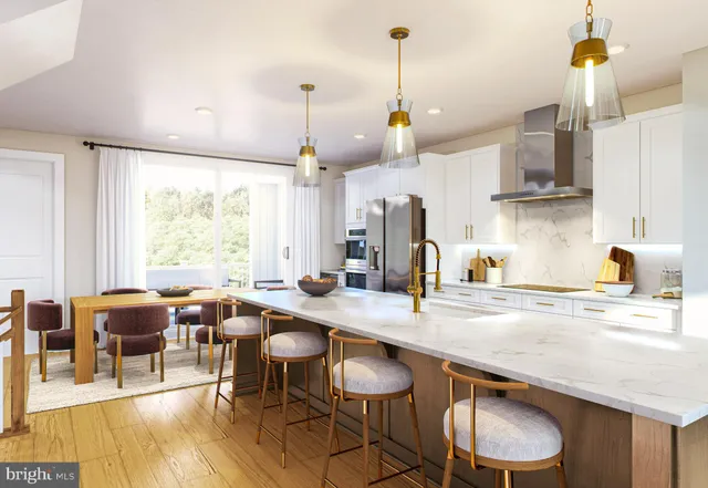 a kitchen with stainless steel appliances granite countertop a sink a stove and chairs