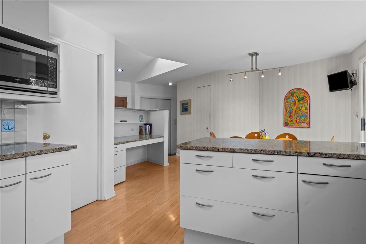 1140 Ridge Road Highland Park, IL 60035 - Photo 14 of 31 a kitchen with stainless steel appliances granite countertop a sink a stove a microwave a refrigerator and cabinets