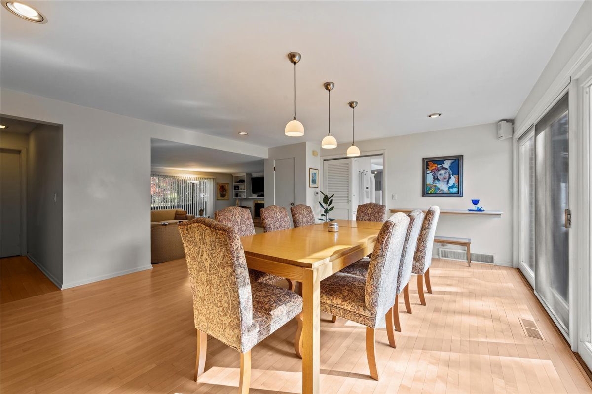 1140 Ridge Road Highland Park, IL 60035 - Photo 10 of 31 a view of a dining room and livingroom with furniture wooden floor a rug a chandelier