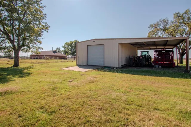 a view of a house with a yard and garage