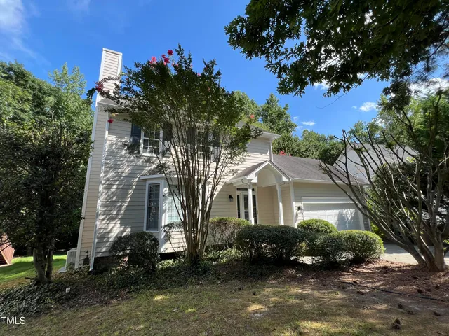 front view of a house with a tree