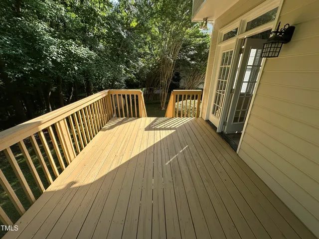 a view of balcony with wooden floor and fence