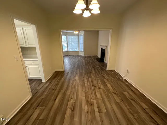 a view of a room with wooden floor and staircase