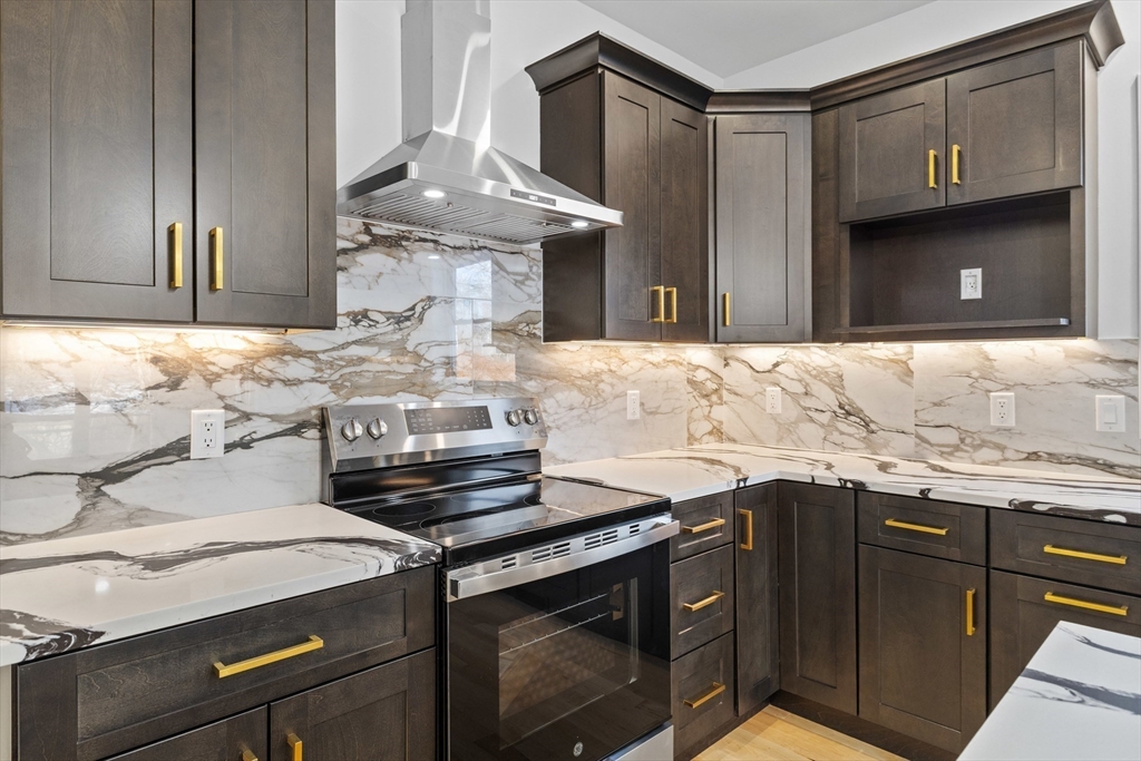 36 Jade Hill Road Auburn, MA 01501 - Photo 12 of 40 a kitchen with granite countertop a stove and a sink