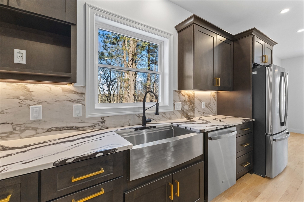 36 Jade Hill Road Auburn, MA 01501 - Photo 13 of 40 a kitchen with a sink stove and refrigerator