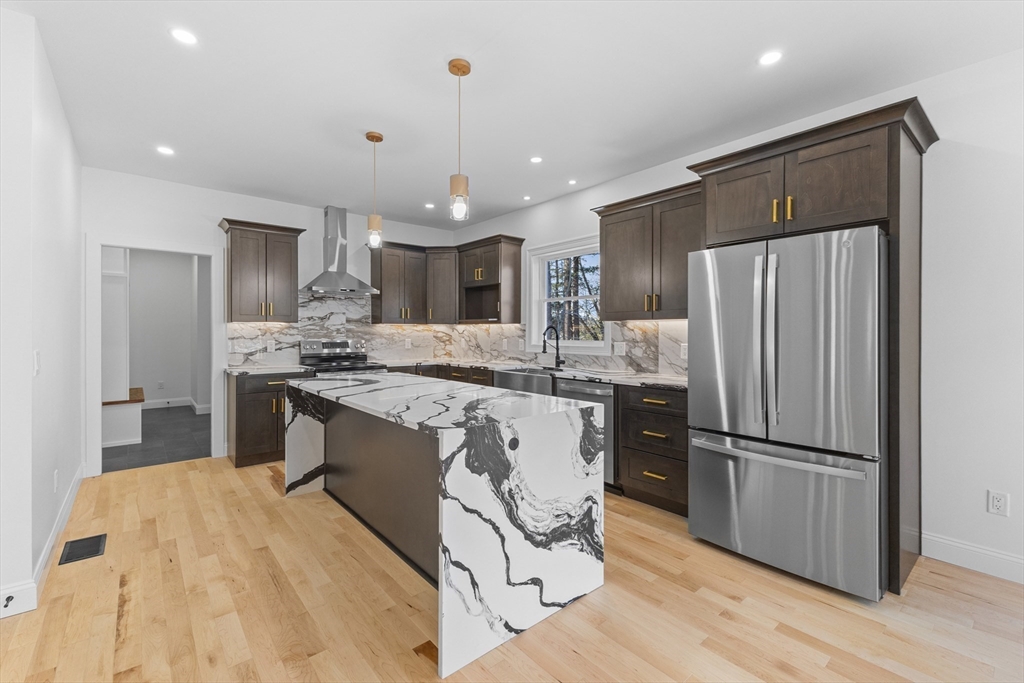 36 Jade Hill Road Auburn, MA 01501 - Photo 14 of 40 a large kitchen with stainless steel appliances kitchen island granite countertop a refrigerator and a sink