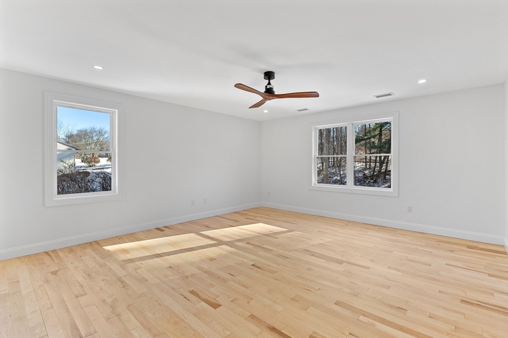 36 Jade Hill Road Auburn, MA 01501 - Photo 19 of 40 a view of a big room with wooden floor and a ceiling fan