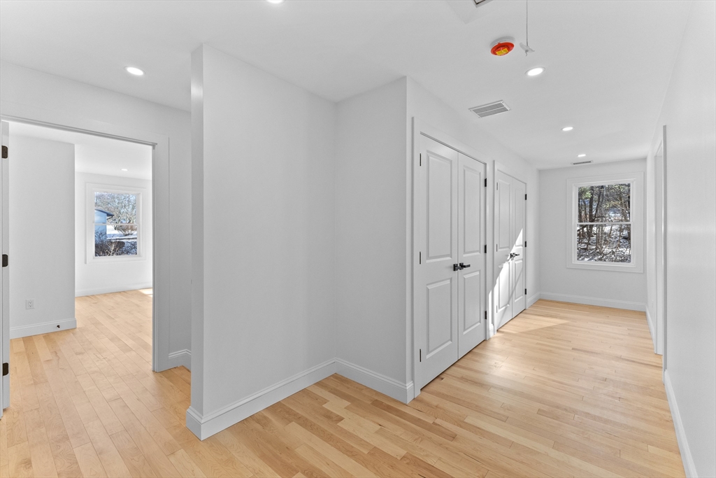 36 Jade Hill Road Auburn, MA 01501 - Photo 26 of 40 a view of a hallway with wooden floor and a bathroom
