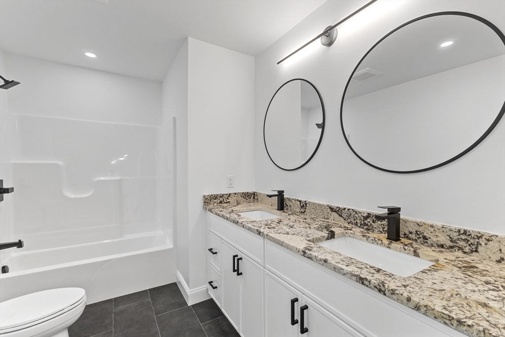 36 Jade Hill Road Auburn, MA 01501 - Photo 27 of 40 a bathroom with a granite countertop sink mirror and a bathtub