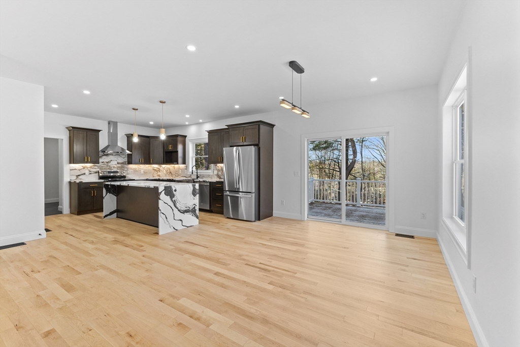 36 Jade Hill Road Auburn, MA 01501 - Photo 9 of 40 a large kitchen with stainless steel appliances kitchen island a large counter top and a refrigerator