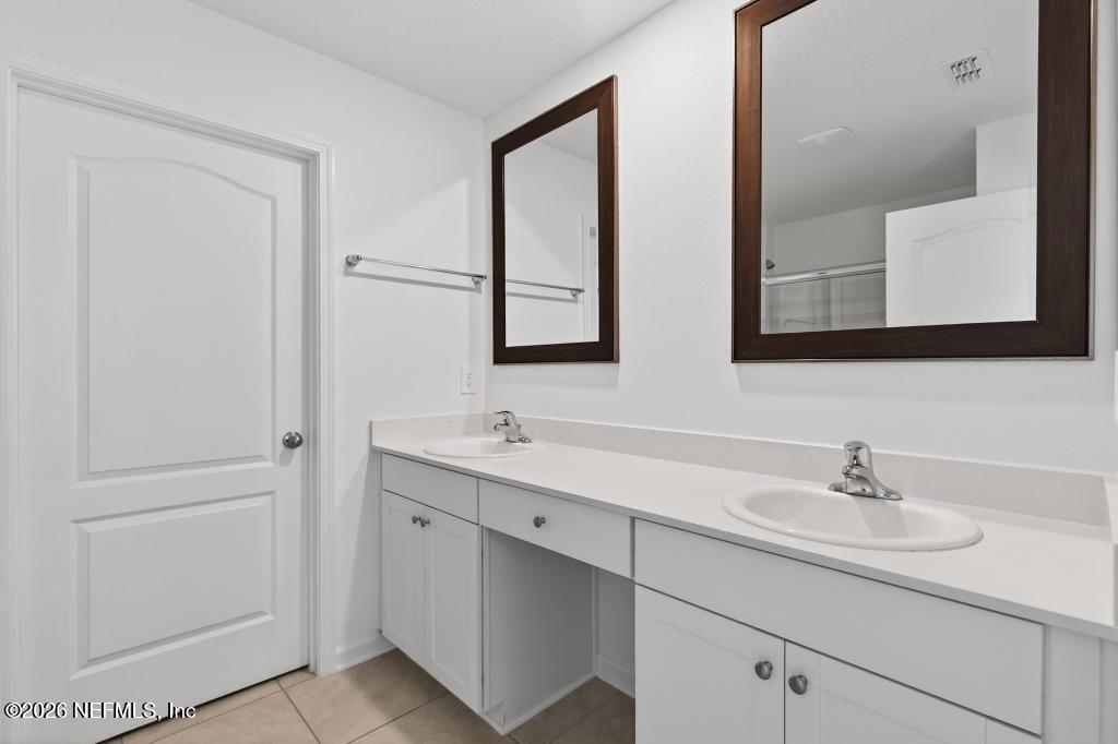45 Seaport Breeze Road St. Augustine, FL 32095 - Photo 70 of 88 a bathroom with 2 sink and a mirror