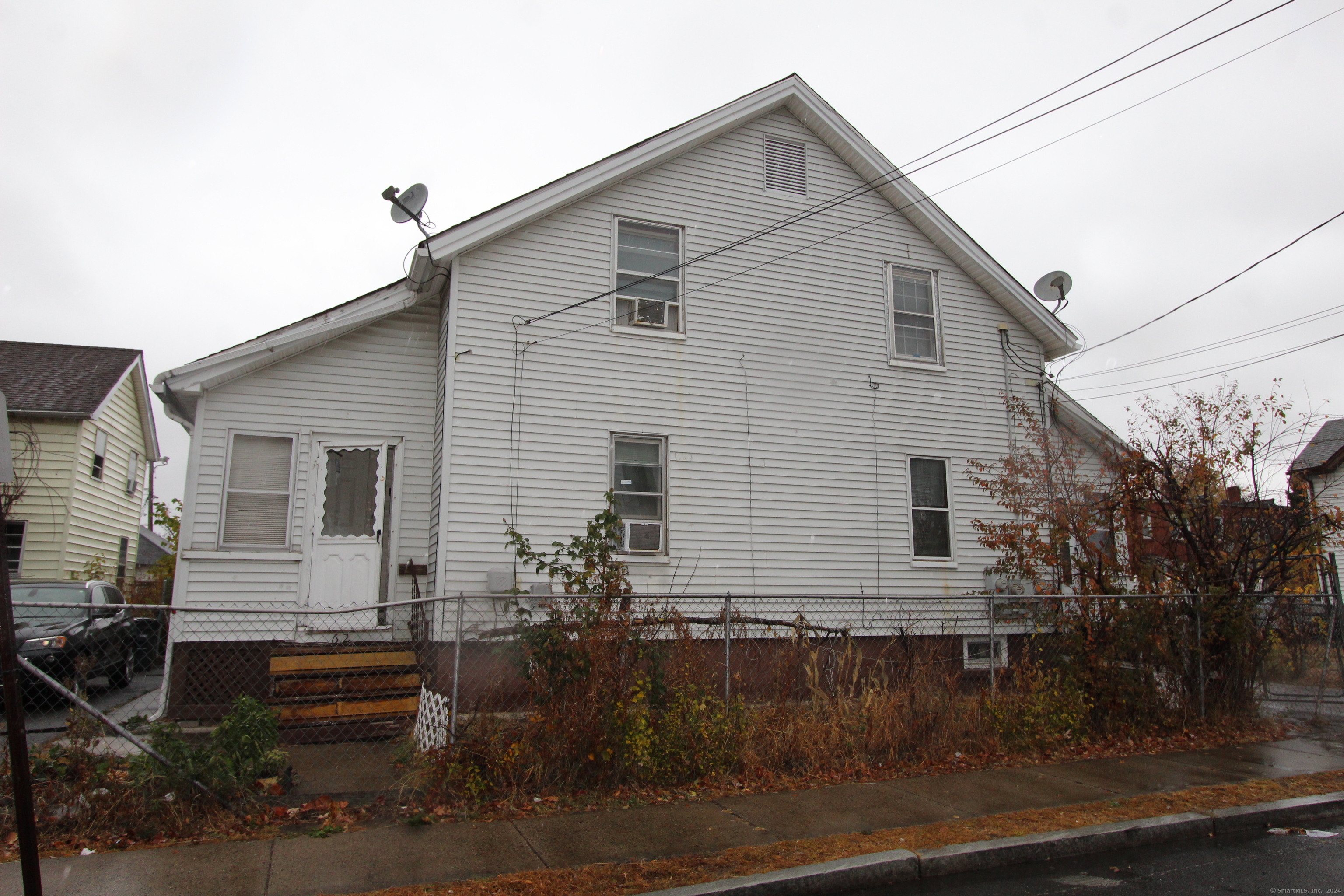 60-62 Bliss Street Hartford, CT 06114 - Photo 1 of 12 a front view of a house with garage