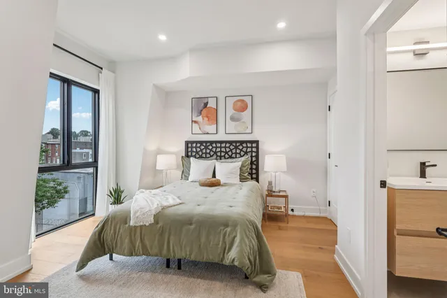 a bedroom with a large bed and a chandelier