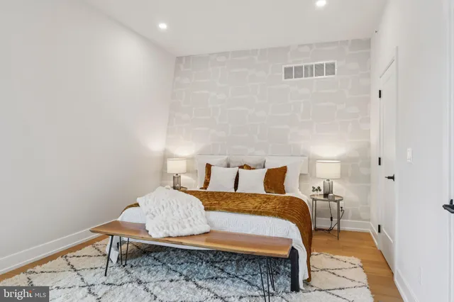 a living room with a bed and a table