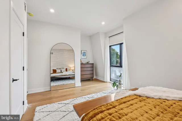 a bathroom with a double vanity sink toilet mirror and shower
