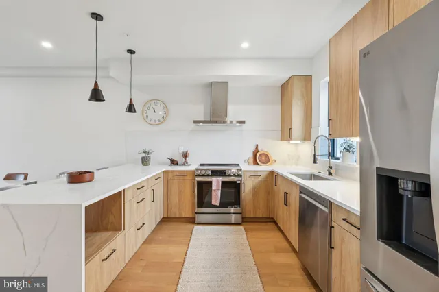 a large kitchen with a stove top oven sink and cabinets