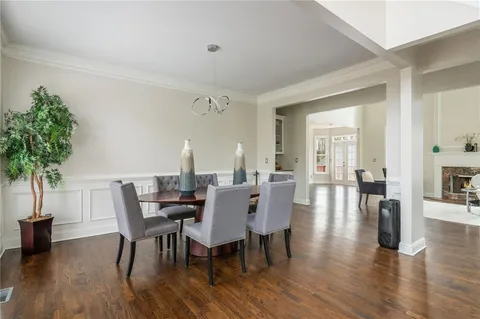 a view of an entryway with wooden floor and a livingroom