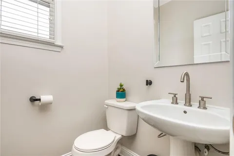 a living room with furniture fireplace and large windows