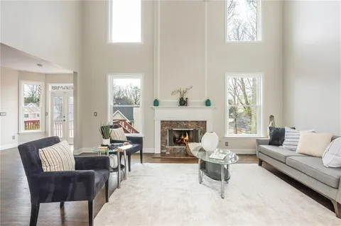 a living room with fireplace furniture and a wooden floor