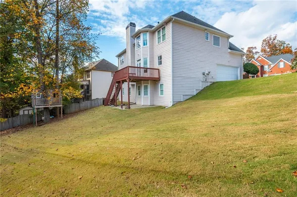 a view of a house with a yard and furniture